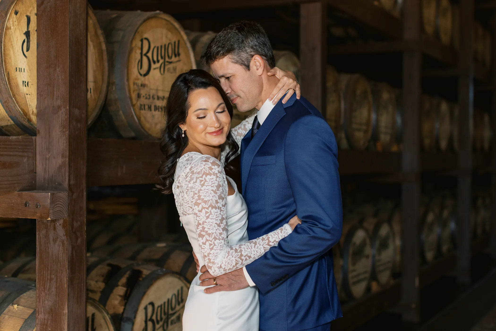 Bayou Rum Distillery Portraits: Lisa & Chris's Secret Elopement Celebration 5 Couple sharing intimate moment during Bayou Rum Distillery portraits in Lacassine Louisiana