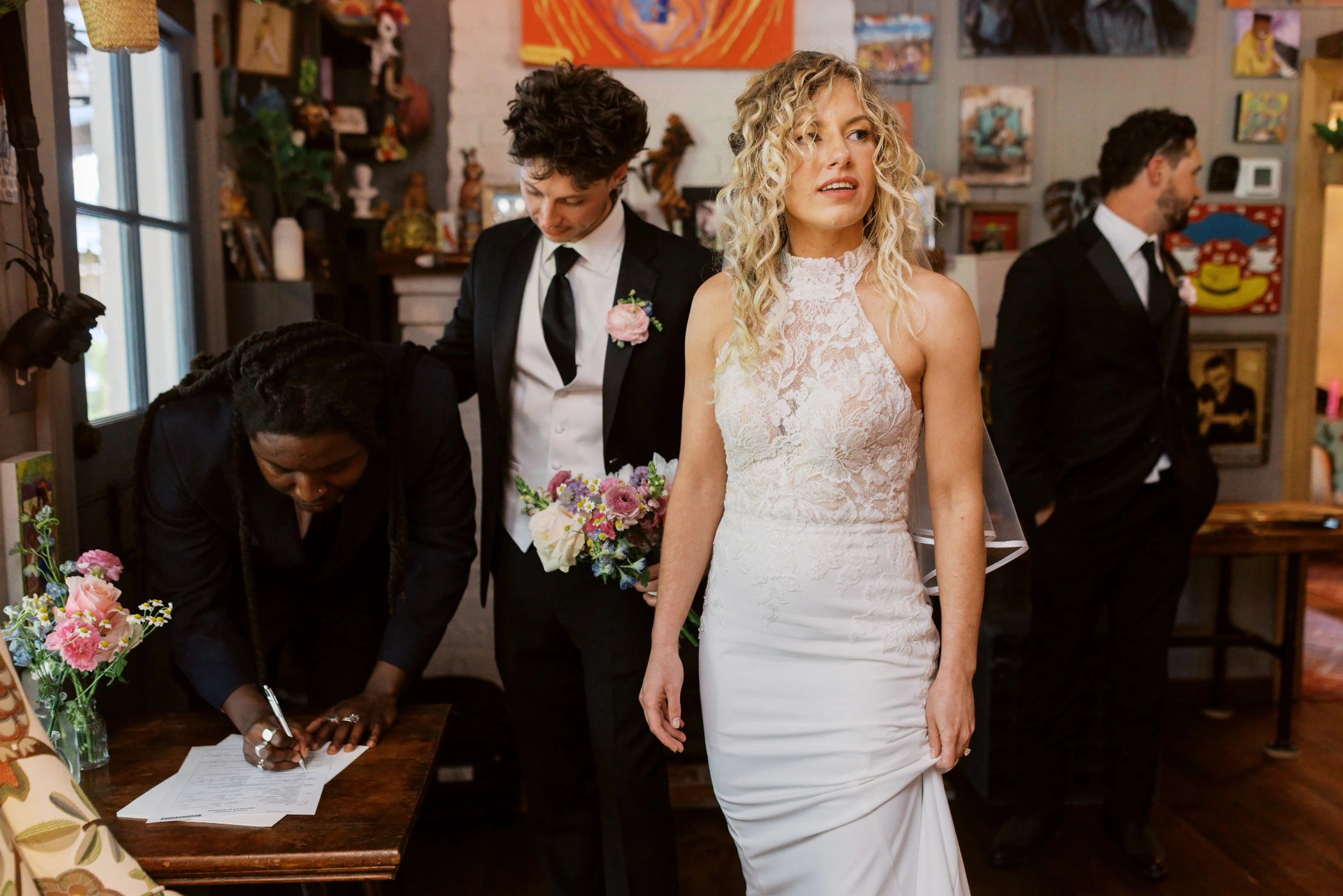 Signing the marriage license inside the art-filled cafe at Cafe Detente in Youngsville