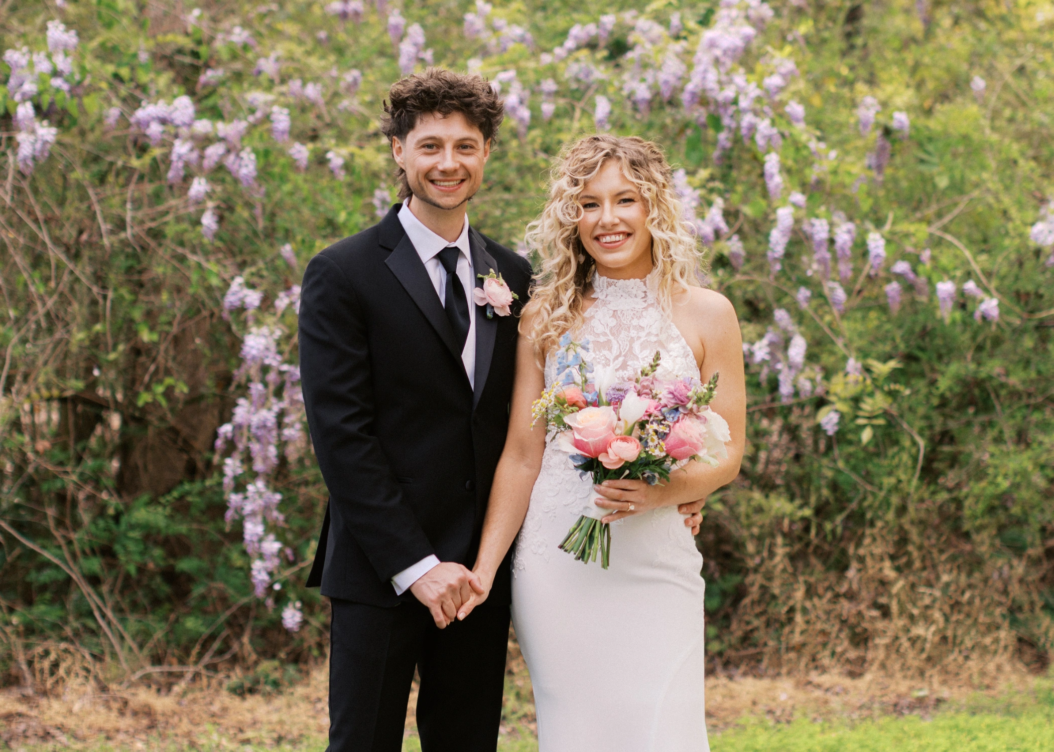Bride & Groom Portrait in front of blooming wisteria